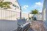 Separate side access to the pool area enhances convenience for guests and outdoor entertaining.