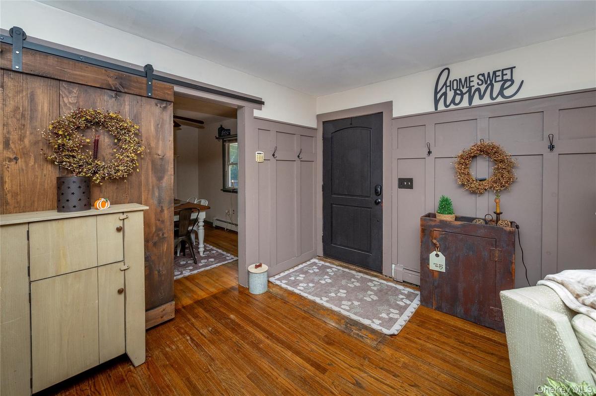 Inside, the spacious living room greets you with hardwood floors.