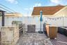The expansive patio is enhanced by a fully equipped barbecue range, creating the perfect setting for outdoor entertaining and dining.