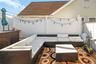 A spacious patio with a well-appointed barbecue area creates an ideal setting for outdoor dining and gatherings.