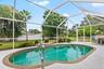 Screened swimming pool with patio space.
