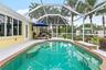 Pool and screened patio along the rear of the home.