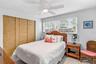 Guest bedroom with built-in closet storage.