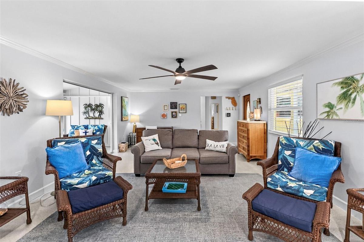 Living room with coastal seating and terrazzo floors.
