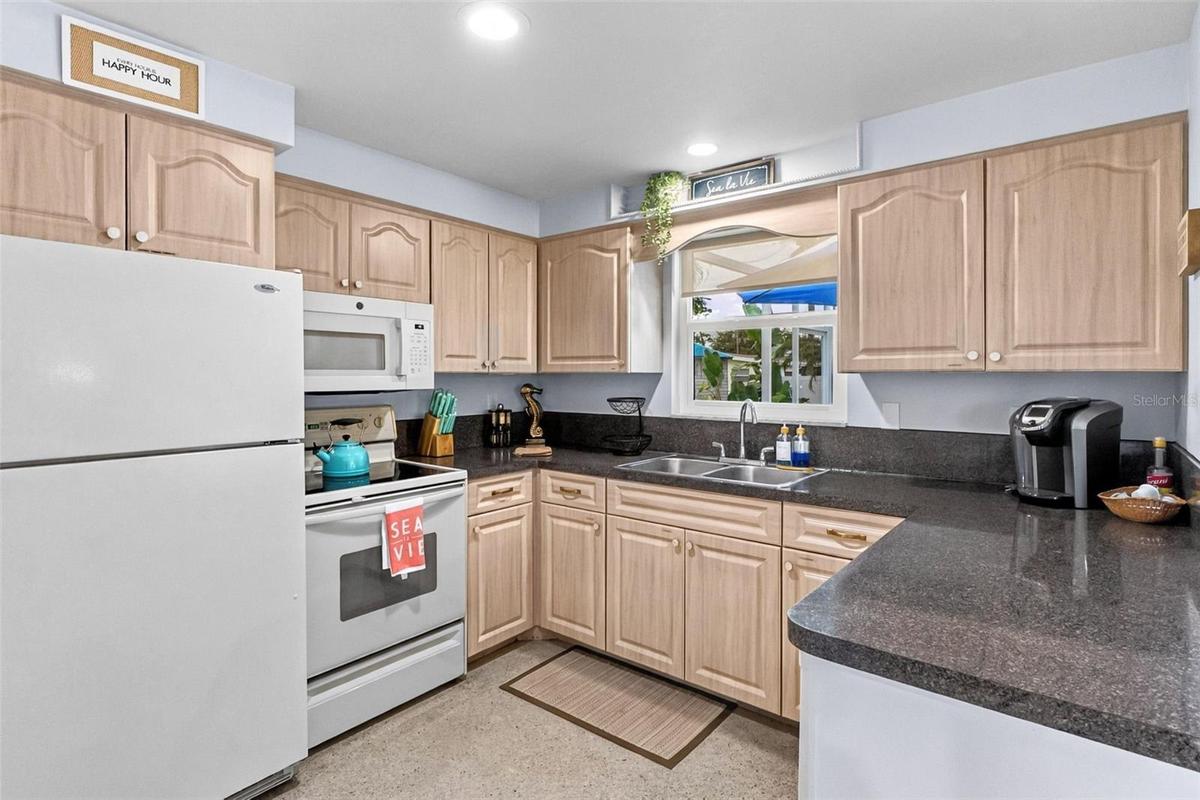 Kitchen with wood-tone cabinetry and ample counter space