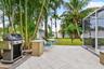 Outdoor patio with grilling and seating areas.