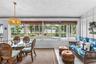 Florida room with dining and sitting areas overlooking the pool.
