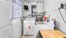 Laundry area with washer, dryer and utility sink.