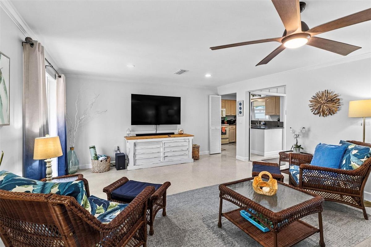 Living room seating area with tropical accents.