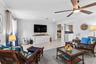 Living room seating area with tropical accents.