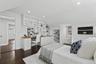 Upstairs bedroom with built-in desk and shelving and walk in closet