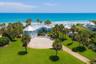 Set on over three-quarters of an acre with approximately 85 feet of ocean frontage, this property offers a generous setback from the road, ample drive