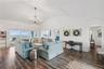 Sweeping Atlantic views take center stage in this bright family room, complemented by coastal furnishings and luxury vinyl plank flooring.