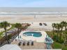 new poolNew oceanfront pool installed in 2024, featuring heating, a sun shelf, bubblers, and a 7-foot-deep end, with expansive patio space and panoram