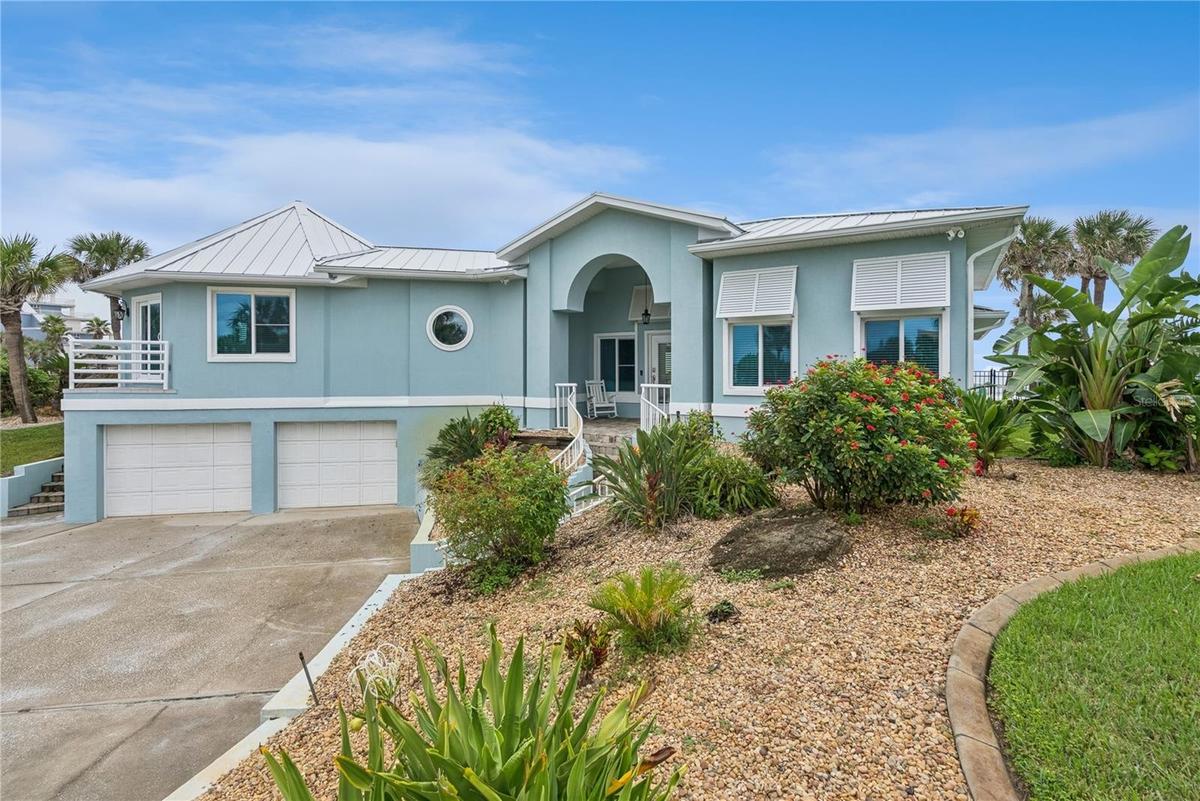 Set on over three-quarters of an acre with approximately 85 feet of ocean frontage, this property offers a generous setback from the road, ample drive