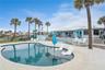 New oceanfront pool installed in 2024, featuring heating, a sun shelf, bubblers, and a 7-foot-deep end, with expansive patio space and panoramic Atlan