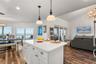 Spacious eat-in kitchen with stainless steel appliances, quartz countertops, breakfast bar seating, and beautiful ocean views—an inviting setting for 