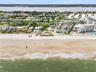 Set on over three-quarters of an acre with approximately 85 feet of ocean frontage, this property offers a generous setback from the road, ample drive