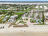 Set on over three-quarters of an acre with approximately 85 feet of ocean frontage, this property offers a generous setback from the road, ample drive