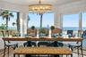 Spacious eat-in kitchen with stainless steel appliances, quartz countertops, breakfast bar seating, and beautiful ocean views—an inviting setting for 