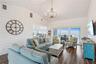 Sweeping Atlantic views take center stage in this bright family room, complemented by coastal furnishings and luxury vinyl plank flooring.