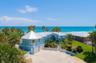 Set on over three-quarters of an acre with approximately 85 feet of ocean frontage, this property offers a generous setback from the road, ample drive