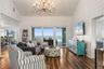 Sweeping Atlantic views take center stage in this bright family room, complemented by coastal furnishings and luxury vinyl plank flooring.