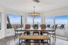 Spacious eat-in kitchen with stainless steel appliances, quartz countertops, breakfast bar seating, and beautiful ocean views—an inviting setting for 