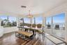 Spacious eat-in kitchen with stainless steel appliances, quartz countertops, breakfast bar seating, and beautiful ocean views—an inviting setting for 