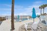 New oceanfront pool installed in 2024, featuring heating, a sun shelf, bubblers, and a 7-foot-deep end, with expansive patio space and panoramic Atlan