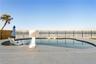 new poolNew oceanfront pool installed in 2024, featuring heating, a sun shelf, bubblers, and a 7-foot-deep end, with expansive patio space and panoram
