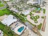 Set on over three-quarters of an acre with approximately 85 feet of ocean frontage, this property offers a generous setback from the road, ample drive