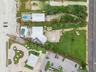 Set on over three-quarters of an acre with approximately 85 feet of ocean frontage, this property offers a generous setback from the road, ample drive