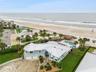 Set on over three-quarters of an acre with approximately 85 feet of ocean frontage, this property offers a generous setback from the road, ample drive