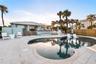 New oceanfront pool installed in 2024, featuring heating, a sun shelf, bubblers, and a 7-foot-deep end, with expansive patio space and panoramic Atlan