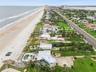 Set on over three-quarters of an acre with approximately 85 feet of ocean frontage, this property offers a generous setback from the road, ample drive