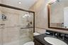 Custom Large Shower, Floor to Ceiling Porcelain Tile With Decorative Tile Borders & Granite Topped Wood Vanity!