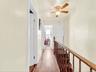 Hardwood-style flooring extends through the hallway