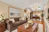 Hardwood flooring, recessed lighting, skylight, vaulted ceiling, and chandelier