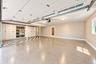 Epoxy-coated flooring, built-in cabinetry with open shelving, checkered flooring, a window, and an interior door with glass panels