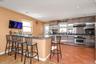 Granite counter top, Birch Cabinets w/Stainless, Ceramic tiled, electric cooking (there is a natural gas line in home)