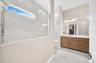 Primary bathroom with dual sinks and large walk-in shower