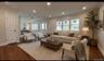 Wood-finish flooring, recessed lighting, crown molding, multiple windows, and a panel-style door Digitally staged