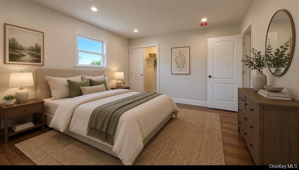 Wood-finish flooring, recessed lighting, and a window for natural illumination Digitally staged