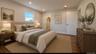 Wood-finish flooring, recessed lighting, and a window for natural illumination Digitally staged