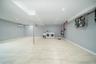 Finished below grade area with a wall mounted air conditioner, recessed lighting, and independent washer and dryer