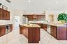 Spacious kitchen features extensive cabinetry, generous counter space, and premium appliances.