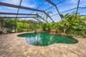 Beautiful custom saltwater pool serves as the centerpiece of the outdoor retreat.