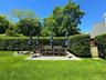 View of grassy yard featuring a fire pit and a patio