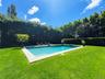 View of swimming pool with a yard